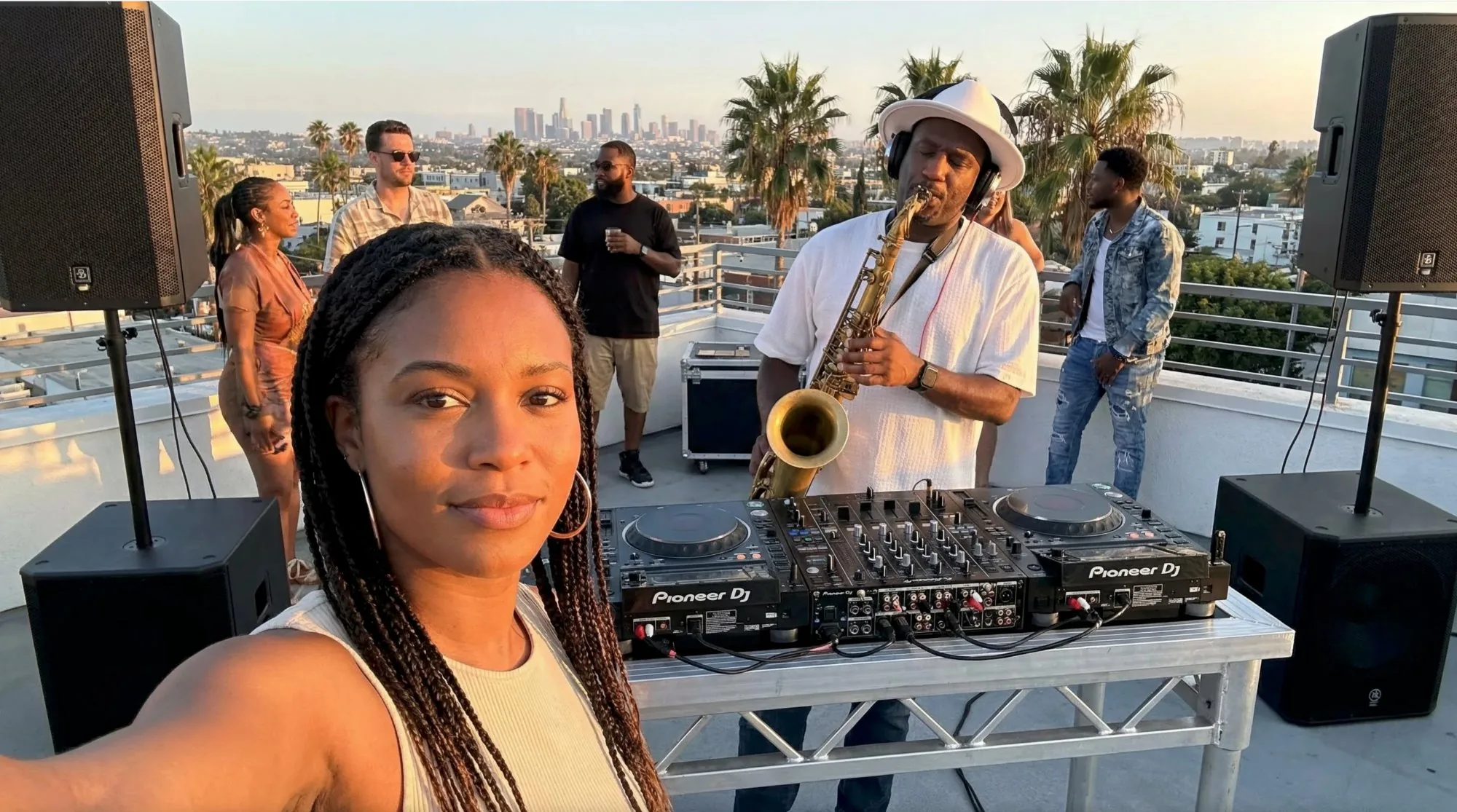 Richie Garrison playing saxophone at Pioneer decks — city rooftop