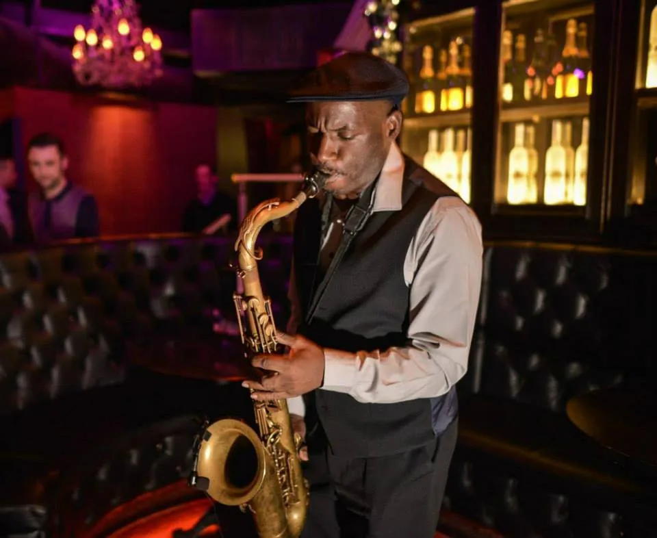 Richie Garrison playing saxophone in a nightlife venue